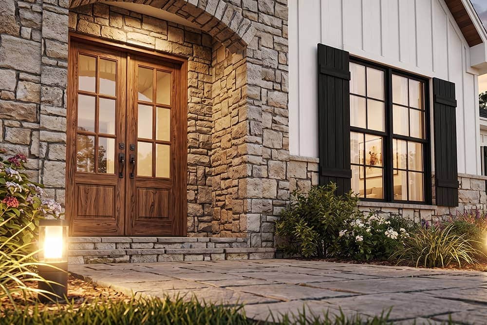 Stone exterior and wood double-door entrance of a Tuscany-style home at Wild Horse Estates
