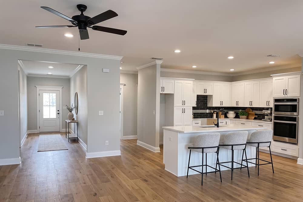 Kitchen and entryway view in a Tuscany style model home in Bullard, Texas