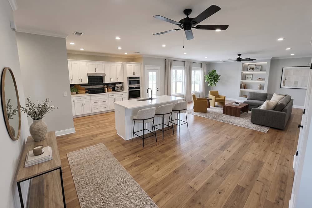 Open concept kitchen and living room in a Country Ranch model home in Wild Horse Estates