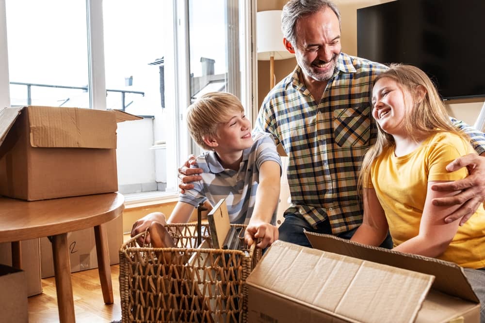 Small Towns in Texas - father and children unpacking boxes in new home