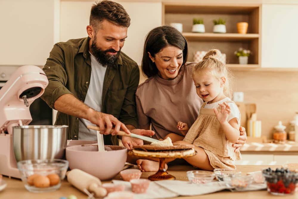 Family enjoying kitchen lifestyle in Tuscany Style Homes community