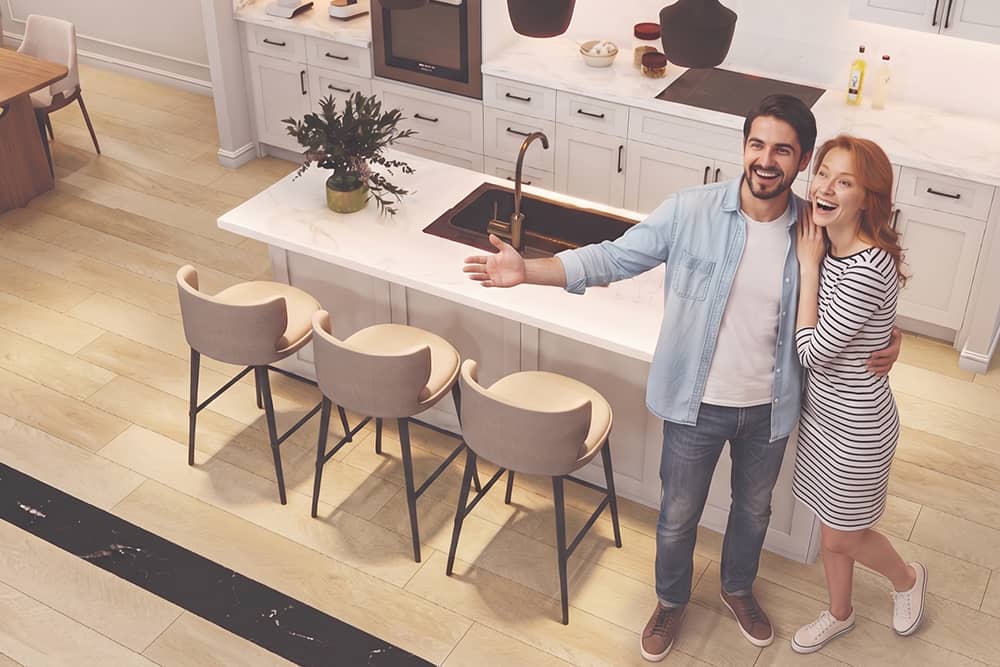 Happy first time home buyers in Texas standing in their new home kitchen
