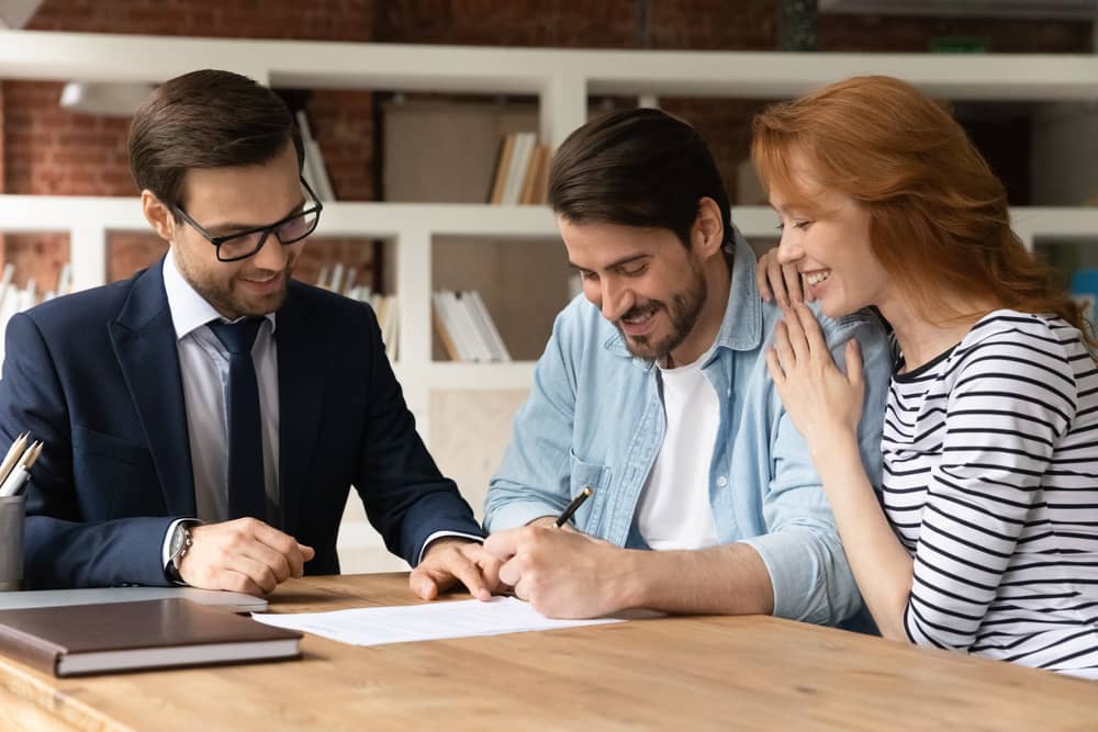 First time home buyers in Texas signing mortgage documents with a participating lender