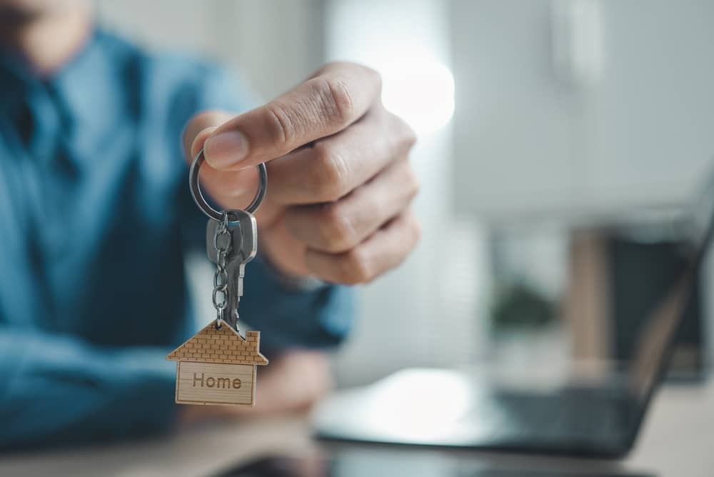 Homes for Rent in Bullard TX: new homeowner holding house keys after buying instead of renting