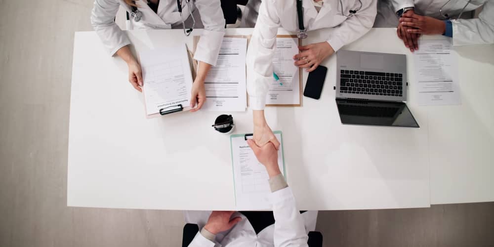Jobs in Tyler TX - hiring panel shaking hands during job interview process
